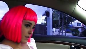 Pink haired slut is posing sexy in a car